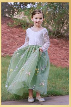 Sage Floral Embroidery Flower Girl Dress Looking for the perfect flower girl dress for your wedding or special occasion? This stunning sage green floral embroidery dress exudes elegance with its intricate designs and sage tones. Your flower girl will be the epitome of grace and charm as she makes her way down the aisle in this captivating creation. The dress features a soft lace bodice with an open V shaped lace trimmed back. The long flowing tulle skirt is lined and has layers of tulle and deep ruffle hemline giving it a mermaid feel. No little girl with be able to resist giving this dress a twirl as this dress just flows with extra amounts of volume. It is perfect for twirling. This dress can be used for many events think weddings for your flower girl, a dress for Easter, a daddy daughte Elegant Green Dress With Floral Applique, Green Embroidered Dress For Dress-up, Spring Princess Dress With Lace Bodice Fitted, Spring Green Dresses With Lace Bodice, Green Lace Bodice Dress For Summer, Spring Green Fitted Princess Dress, Green Embroidered Dress For Dress-up Occasions, Long Sleeve Floral Embroidered Tulle Dress, Fitted Princess Dress For Spring Wedding