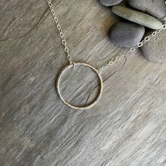 This is a simple sterling silver hammered circle necklace that makes a perfect gift for a teacher, hostess, or loved one. And, it looks great by itself or layered with other chains. Here are the details: It has a 1" circle that has been hammered for texture. The finished length is available in 16 or 18 inches. Chain style may vary, depending on what I have on hand...although it will always be sterling silver. Nickel-free Sterling Silver Circle Necklaces, Sterling Silver Nickel-free Open Circle Necklace, Hammered Sterling Silver Round Pendant Jewelry, Hammered Sterling Silver Round Pendant, Everyday Nickel-free Infinity Jewelry, Simple Adjustable Hammered Jewelry, Sterling Silver Hammered Circle Jewelry, Hammered Circle Jewelry As Gift, Hammered Sterling Silver Circle Jewelry