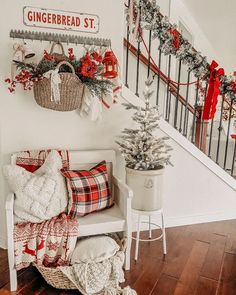 a christmas scene with red and white decorations on the stairs, wreaths and garland