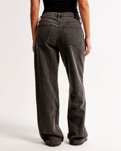 Our Curve Love low rise baggy jeans in a dark grey wash with a clean hem. This fit features a 8.5” low rise, is slightly relaxed at waist and hips, and eases at the thigh into a baggy, full-length leg shape. The viral fit that eliminates waist gap: Curve Love features additional room through the hip and thigh for curve-hugging comfort. We recommend buying your true size for a baggier fit. Size down for a closer fit. This jean is made from our vintage stretch fabric which features both an authentic vintage look and contains slight built-in stretch for additional comfort. Low Rise Baggy Jeans, Baggy Jean, Women's Bottoms, Grey Wash, Baggy Fits, Baggy Jeans, Vintage Looks, Abercrombie Fitch, Dark Gray