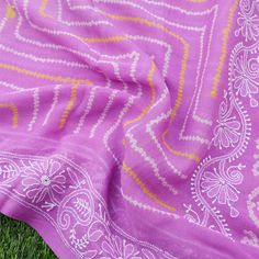 Introducing our exquisite Bandhani Saree with Chikankari Border, a beautiful blend of traditional craftsmanship and elegance. This stunning saree showcases the timeless artistry of the Bandhani tie-dye technique, combined with delicate Chikankari embroidery along the border. Each Bandhani saree is meticulously handcrafted, using the ancient technique of tying and dyeing fabric to create intricate patterns. The Chikankari border further enhances the beauty of this saree, with its fine and delicat Traditional Purple Saree With Chikankari Embroidery, Purple Bandhani Print Traditional Wear For Diwali, Purple Bandhani Traditional Wear For Diwali, Bohemian Chanderi Saree With Chikankari Embroidery, Diwali Purple Bandhani Traditional Wear, Traditional Drape Mulmul Saree With Chikankari Embroidery, Bohemian Chikankari Embroidered Saree For Festivals, Purple Traditional Wear With Bandhani Print, White Chanderi Dupatta With Bandhani Print