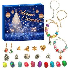 an assortment of christmas jewelry and ornaments in front of a blue box with the words merry calendar written on it