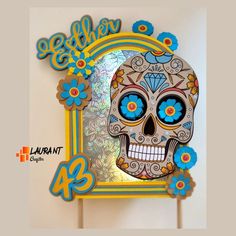 a colorful sugar skull with blue eyes on a stick