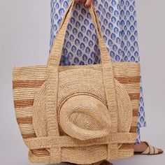 Our favorite Original Straw Traveler Bag now in a stripe colorway is sure to brighten up your spring and summer with a special built in spot for you favorite sunhat! Packable for easy travel and roomie for all of your sarongs, bathing suits and sunscreen. *Hat sold separately Product Overview: Material: 100% Raffia Straw, 100% Cotton Lining Measurements: 20" x 14", Handle Drop- 10" Spot Clean with Damp Cloth Travel Tote Shoulder Bag With Striped Lining, Striped Beach Bag For Everyday Summer Use, Striped Bags For Spring Beach Outings, Spring Striped Beach Bags, Spring Beach Striped Bags, Striped Travel Bags With Adjustable Strap, Striped Travel Bags For Summer, Striped Summer Style Bag, Striped Straw Bag For Travel