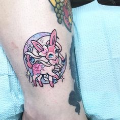 a person with a tattoo on their leg that has an image of a rabbit in the center