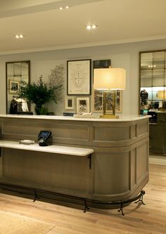 the front desk of a hotel lobby with a cell phone on it's counter