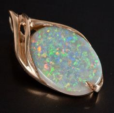 14k Yellow Gold Oval Cabochon White "AAA" Opal Solitaire Style Pendant 7.11ctMetal Information: 14k Yellow GoldTotal Weight: 6.91gPendant Width: 19.6mmPendant Length: 34.9mmStone InformationMain StoneGem Type: OpalShape: Oval Cabochon (22.5mm x 17.3mm)Color: WhiteClarity/Quality: AAACarat Weight: 7.11ctNumber of Stones: 1Total estimated ctw (carat total weight): 7.11ctwEstimated Retail Price: $6730.00OUR PRICE: $5385.0045346 Formal Oval Cabochon Opal Jewelry, Formal Opal Jewelry With Oval Cabochon, White Oval Cabochon Gemstones, Oval Polished Cabochons For Gifts, 14k Gold Oval Cabochon Gemstones, Oval Cabochon Gemstones In 14k Gold, Jewelry Website, Custom Jewelry Design, Beautiful One