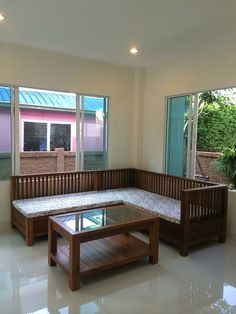 a living room filled with furniture next to two large windows on top of a white tiled floor