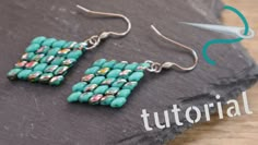 a pair of turquoise beaded earrings sitting on top of a slate slab with the words,