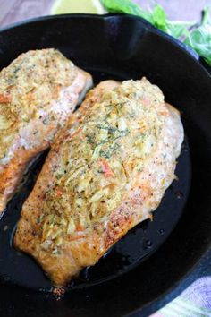 two fish fillets in a skillet on a table