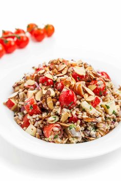 a white bowl filled with rice and tomatoes