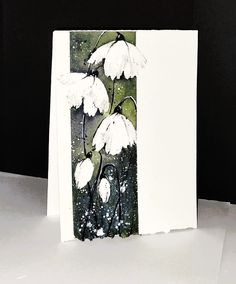 a card with white flowers on it sitting on a table