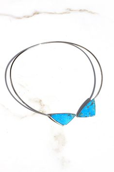 This contemporary blue turquoise sterling silver collar style necklace is fashionable and lightweight. Two triangular turquoise stones have been cut and set in smooth sterling silver bezels. They are connected to a pliable sterling silver collar that lays comfortably around your neck. Slip it on and forget about it until the compliments roll in. If you love modern designs this piece will fit your style. Silver Eagles, Turquoise Stones, Style Necklace, Blue Turquoise, Collar Necklace, Turquoise Sterling Silver, Turquoise Stone, Turquoise Blue, Collar Style