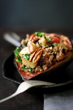 a close up of a plate of food on a table with a fork and spoon