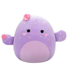 a purple stuffed animal with pink flowers on its head