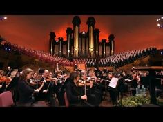 an orchestra performing in front of a large pipe organ