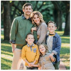 a family posing for a photo in the park