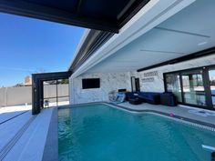 an indoor swimming pool with sliding glass doors