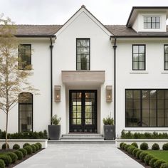 a large white house with black windows and doors