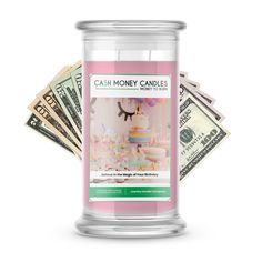 a pink candle sitting on top of a pile of money