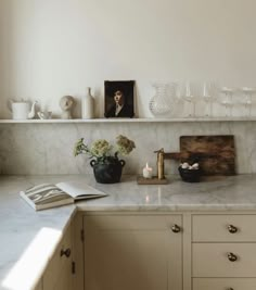 a kitchen counter topped with lots of white dishes