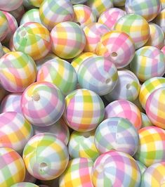 many different colored balls are stacked together