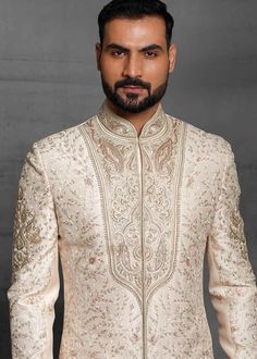 Custom Made Designer Off White Designer Groom Sherwani
Designer custom made ivory fully embroidered sherwani with chudidar in UK . The latest heavy silk embroidered sherwani is best choice for groom . It is suited for Indian and Pakistani wedding wear . 
One of the standout features of this sherwani is the intricate embroidery adorning its surface. Our skilled artisans have meticulously handcrafted every detail, using fine threads and intricate patterns that showcase traditional Indian craftsmanship at its best. The embroidery showcases a harmonious blend of motifs, ranging from floral designs to intricate geometric patterns, creating a visually stunning ensemble that captures attention and admiration . Please note there can be slightly difference between the image and the product due to Groom Sherwani, Off White Designer, Zari Embroidery