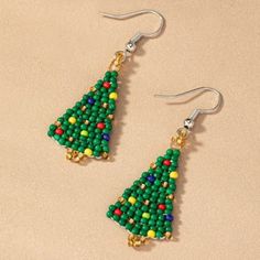 the beaded christmas tree earrings are made with beads