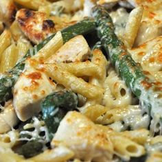 a pasta dish with chicken, asparagus and spinach