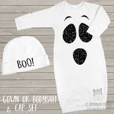 a baby's halloween outfit and hat with the word boo written on it in black