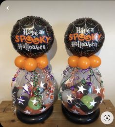 two halloween balloons sitting on top of each other