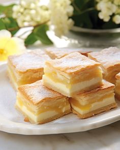 several pieces of cake on a plate with flowers in the background