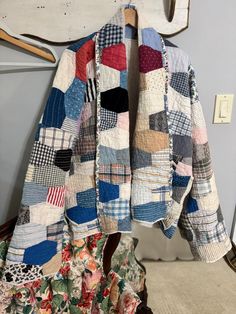 a patchwork jacket hanging on a clothes rack