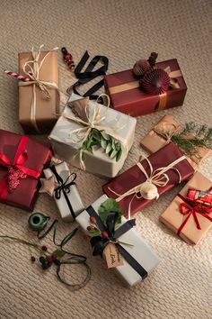 many wrapped presents are laying on the floor