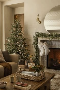 a living room filled with furniture and a fire place next to a christmas decorated tree