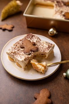 a piece of cake sitting on top of a white plate next to a christmas ornament