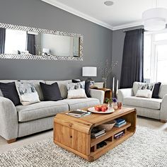 a living room with two couches and a coffee table in front of a window