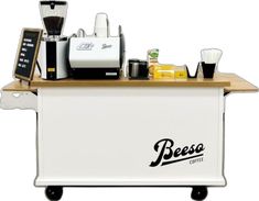 a white coffee cart with various items on the top and below it that says besco coffee