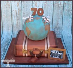 a cake that is shaped like a suitcase and has the number 70 on it,