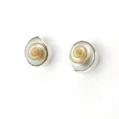 Iridescent malabar shells are set in a bezel sterling silver setting. Post earrings are 1/2 inch wide and come inside a jewelry gift box. Style Number: 938 Metal: 925 Sterling Silver Gemstone: Genuine Malabar Shell Dimensions: 1/2 inch high Handmade in Bali, Indonesia Silver Mother Of Pearl Shell Gift, Unique Silver Shell Earrings, Silver Shell-shaped Mother Of Pearl Jewelry, Nickel-free Silver Shell As Gift, Sterling Silver Shell-shaped Gift, Sterling Silver Shell Earrings For Gift, Unique Silver Shell As A Gift, Elegant Silver Shell With Matching Earrings, Jewelry Gift Box