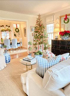 a living room filled with furniture and a christmas tree