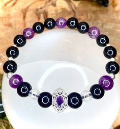 Protective bracelet made by hand in semi-precious stones (amethysts, onyx and crystal aura angel). Silver plated spacers. Soothing and protective, it will act to repel negative energies, dissolve bad thoughts and bring a little light and purity. Each piece being made individually for orders, there may be color variations due to the uniqueness of the stone. Do not hesitate to join us on our facebook page or Instagram "Desarwen" to view the videos of our shop from La Rochelle, and all of our wonde Spiritual Healing Crystal Bracelet With Spacer Beads, Spiritual Amethyst Crystal Bracelet, Spiritual Silver Amethyst Crystal Bracelet, Black Amethyst 8mm Bead Bracelets, Black Amethyst Bracelets With 8mm Beads, Black Amethyst Bracelet With 8mm Beads, Spiritual Purple Crystal Bracelet With Spacer Beads, Black Amethyst Beaded Bracelets Spiritual, Black Amethyst Crystal Bracelet In Spiritual Style