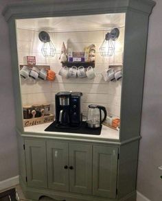 a coffee maker is sitting on top of a cabinet in the corner of a kitchen