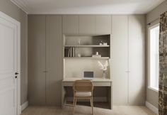 an empty room with a desk, chair and bookshelf