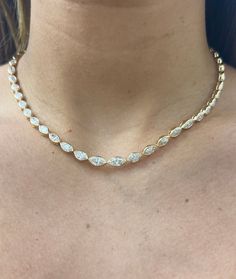 When the occasion calls for a grand entrance, this necklace is here for every milestone. Handcrafted in 14k solid gold featuring 49 diamonds, with an average total carat weight of 6.90cts that are bezel set to create a continuous stream of shine. Available in 14k Yellow Gold, White Gold, and Rose Gold Diamond Total Carat Weight: approximately 6.90cts Available in Oval, Princess, Marquise and Pear cuts Diamond Color: F-G Diamond Clarity: VS1 Diamonds appear halfway around the neckline. Made to or Luxury Rose Gold Diamond Necklace With Bezel Setting, Luxury Yellow Gold Diamond-cut Station Necklace, Luxury White Gold Station Necklace For Anniversary, Necklace Outfit, Vs1 Diamond, Custom Wedding Rings, Pear Cut Diamond, Tennis Necklace, Grand Entrance