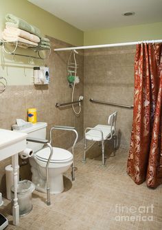 a bathroom with a toilet, sink and shower curtain in it's corner is shown