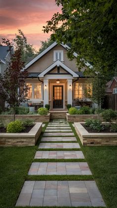 a house that is in the grass with steps leading up to it's front door