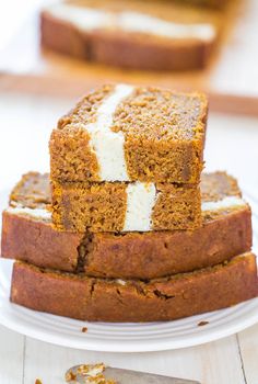 three slices of pumpkin bread stacked on top of each other with cream cheese in between