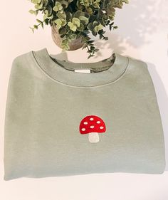 Joyfully Embroidery crafts embroidered crewneck sweatshirts. Each design is thoughtfully embroidered. This cute mushroom 🍄 design is perfect to cozy up in all season long. This soft sweater has a relaxed fit for a comfortable feel. About your crewneck sweater: This is the perfect blend of 50% preshrunk cotton and 50% polyester, pill-resistant air jet yarn, double stitching, set-in sleeves, ribbed collar and cuffs, and hefty weight of 8 ounces. 8.0 oz., 50/50 pre-shrunk cotton/polyester Reduced Cotton Fall Sweatshirt With Mushroom Print, Cotton Sweatshirt With Mushroom Print, Cotton Sweatshirt With Mushroom Print For Fall, Cotton Crew Neck Sweatshirt With Mushroom Print, Cottagecore Cotton Crew Neck Sweatshirt, Cotton Long Sleeve Sweatshirt With Mushroom Print, Fall Cottagecore Crew Neck Sweatshirt, Cottagecore Sweater, Embroidery Crafts