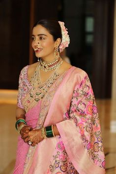 a woman in a pink sari and jewelry